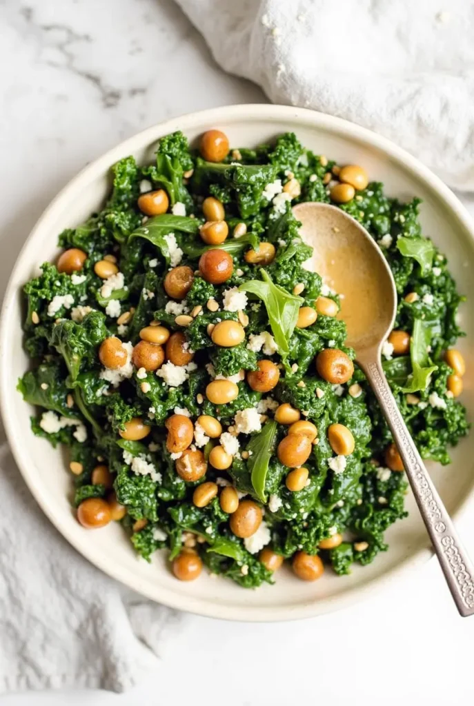 A hearty kale salad with roasted vegetables and a drizzle of maple tahini dressing.